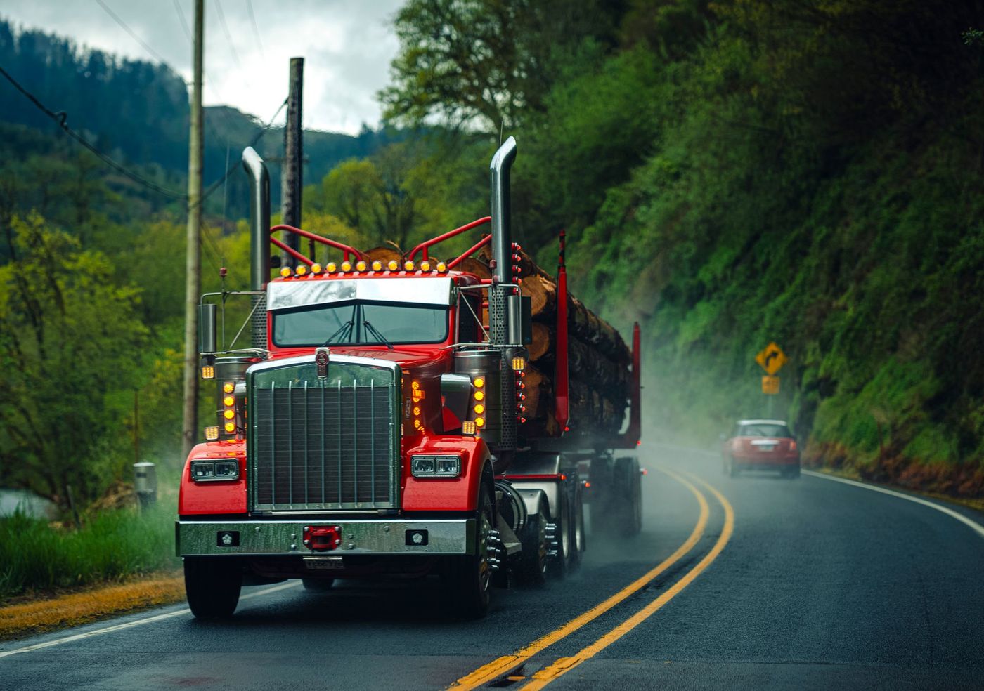 A loaded tractor-trailer on a wet highway